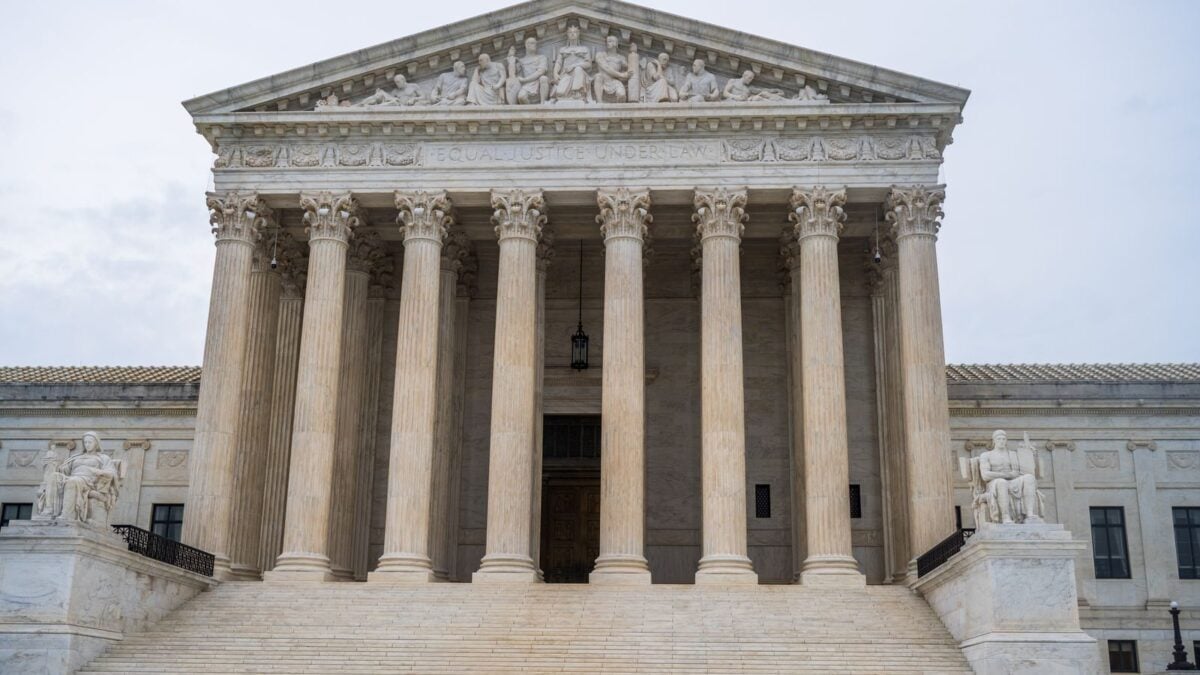 Front view of the iconic US Supreme Court building showcasing its grand columns and classic architecture.